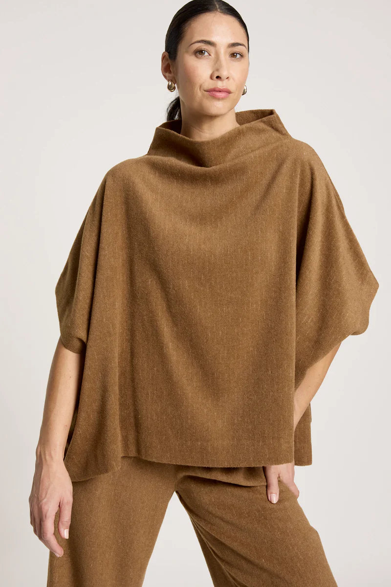 woman wearing Azul Poncho in Clay