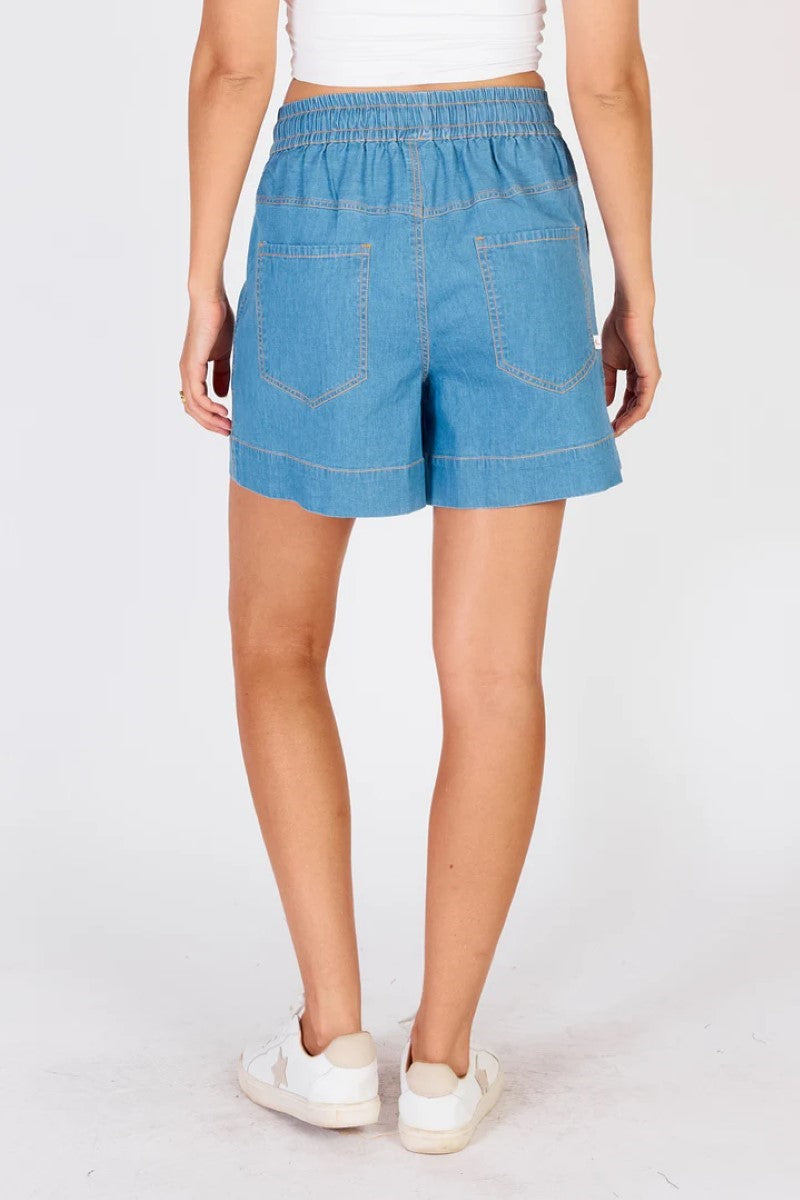 Person wearing blue shorts on a white background
