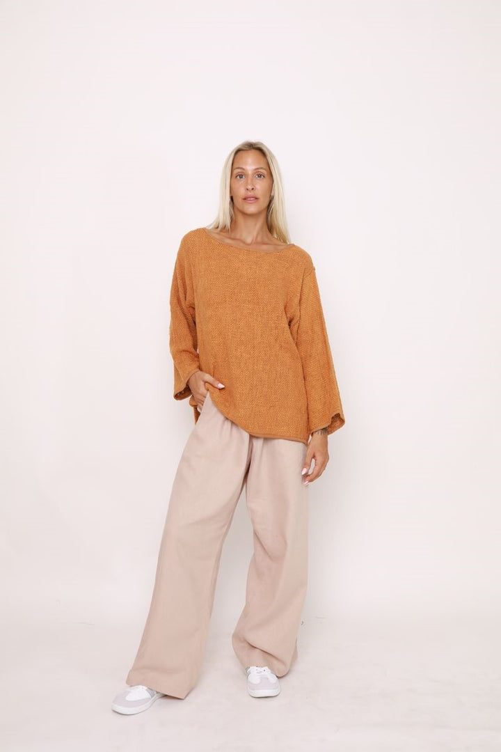 Front view of the Elena Top in Bran, displayed at Ivy Vibe, featuring a relaxed oversized fit, round neckline, and long sleeves in handwoven cotton hessian fabric.