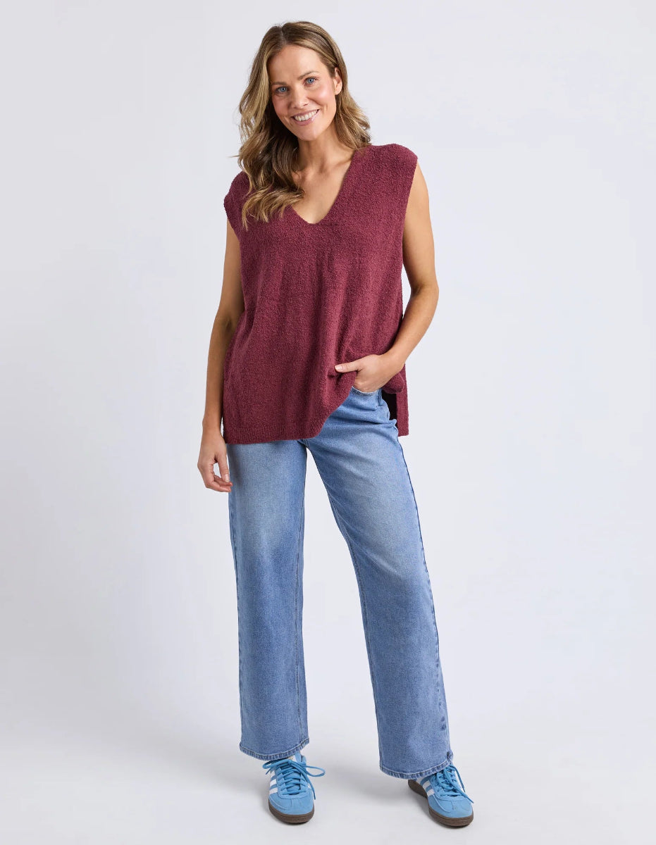 Full outfit with plum knit top, jeans, and sneakers.