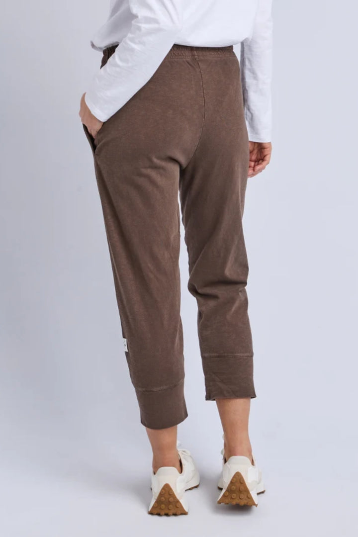 Brown pants worn by a person on a white background