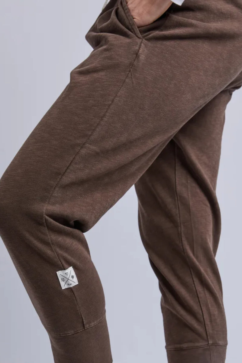 Brown pants with a small logo on a light gray background
