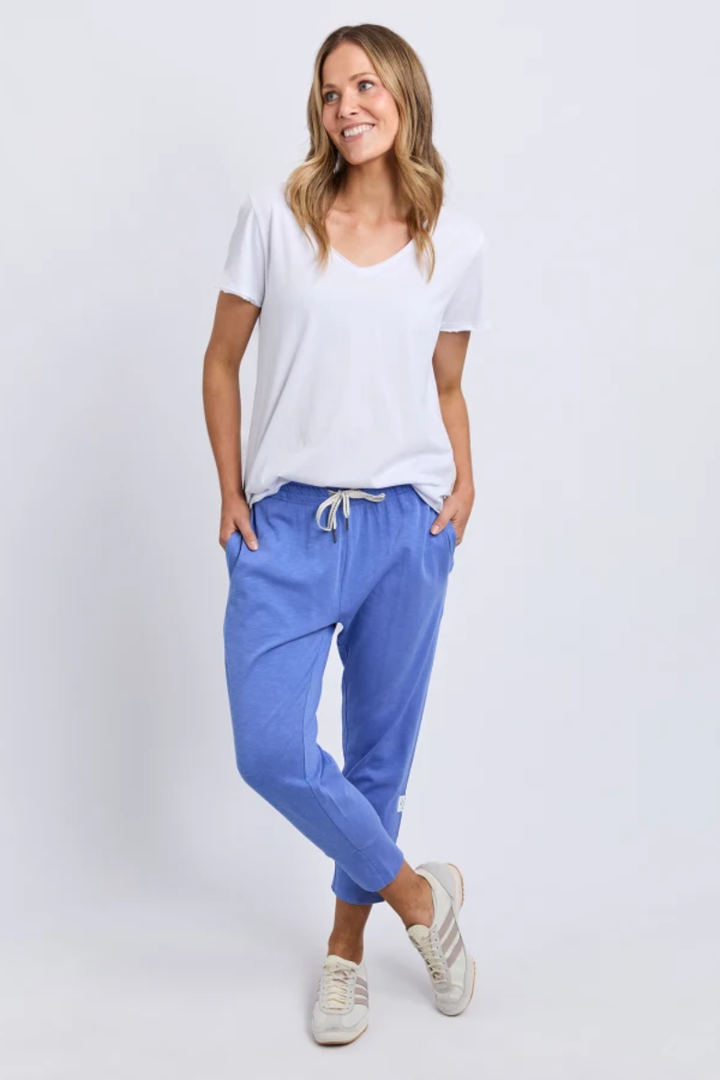 Woman wearing a white t-shirt and blue pants on a white background