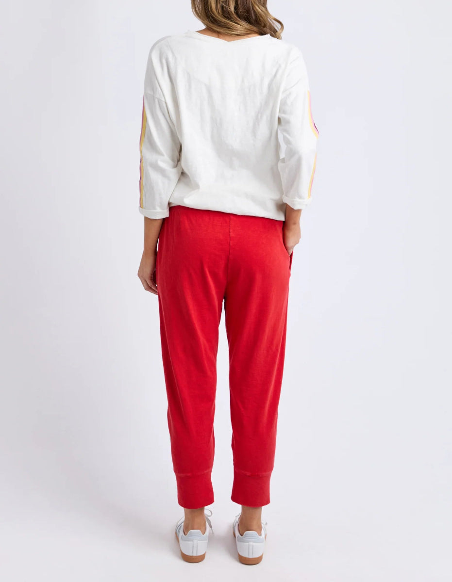 Back view of red cropped jogger pants with elastic cuffs.