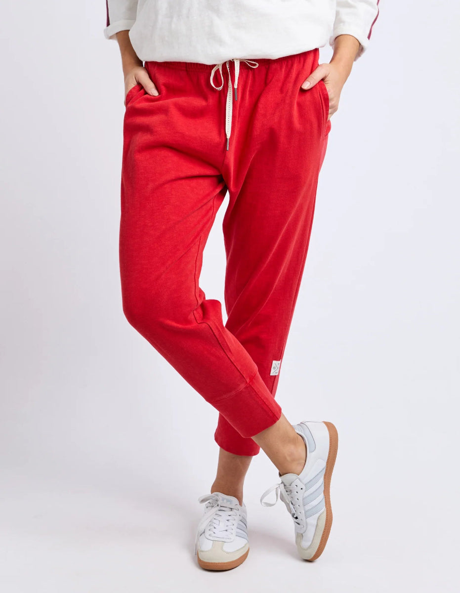 Close-up of red cropped jogger pants with drawstring waist.