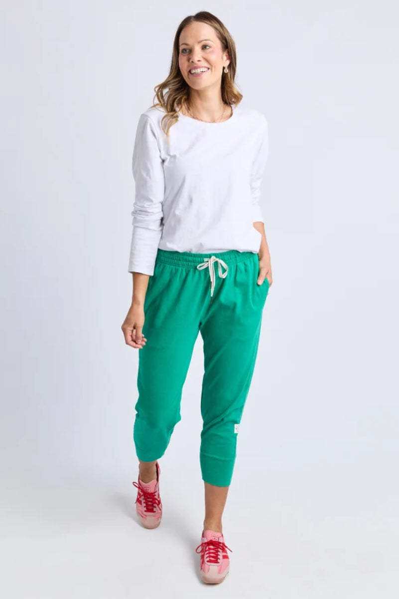 Front view of teal cropped jogger pants with side pockets.