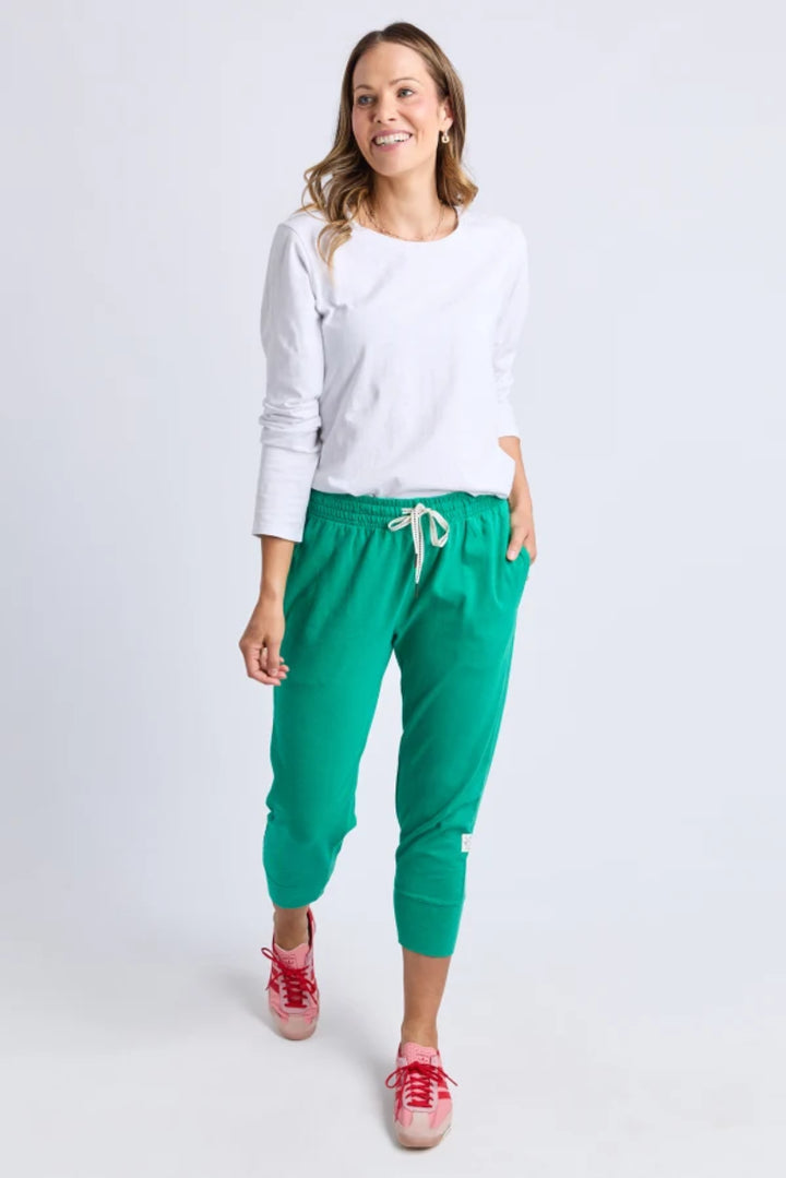 Front view of teal cropped jogger pants with side pockets.