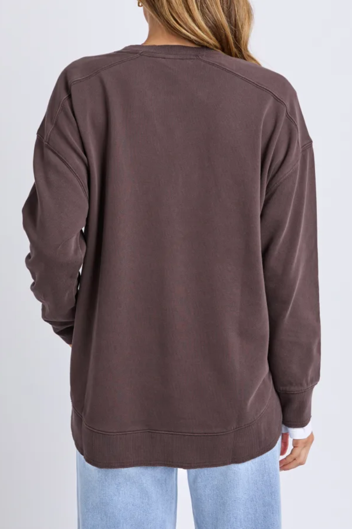 Brown sweatshirt worn by a person on a white background