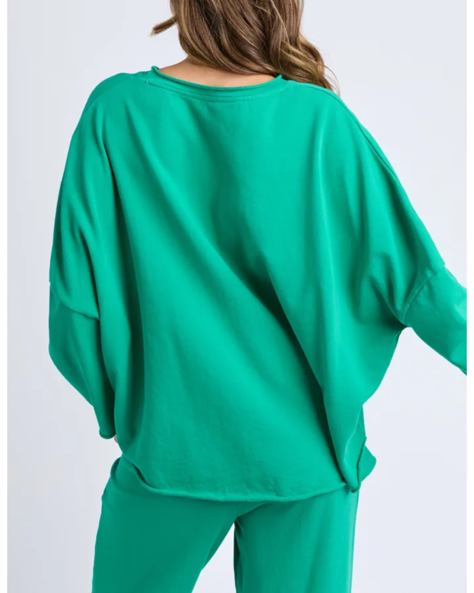 Green outfit worn by a person on a white background