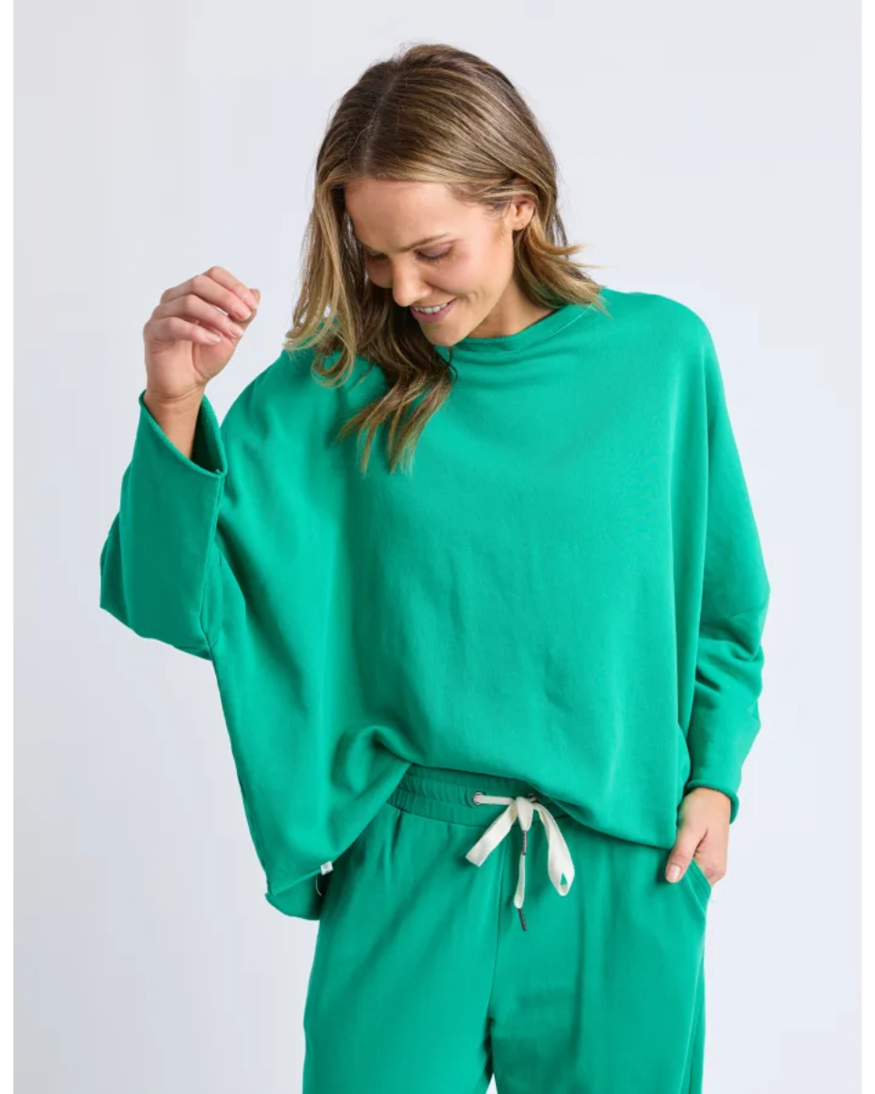 Woman wearing a green outfit on a white background