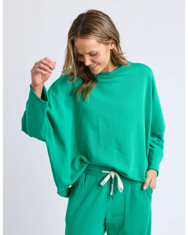 Woman wearing a green outfit on a white background