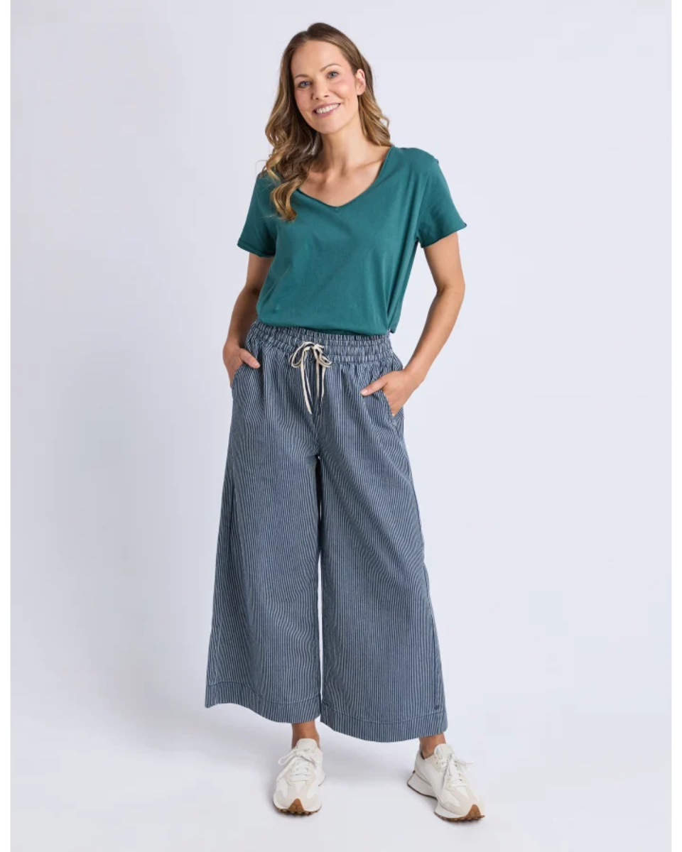 Front view of teal V-neck tee with striped wide-leg pants.