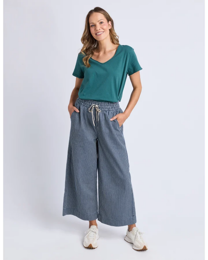 Front view of teal V-neck tee with striped wide-leg pants.