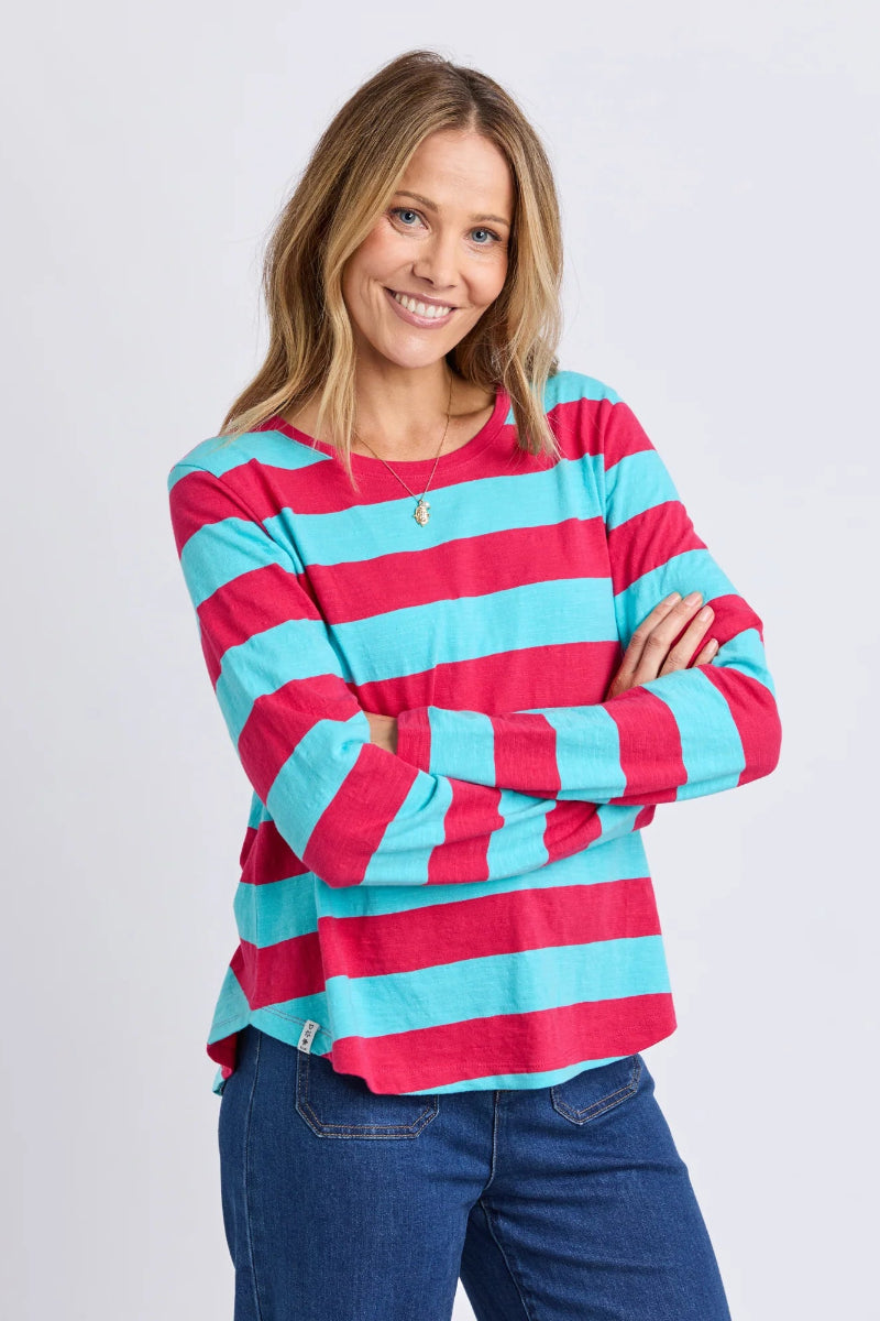 Woman wearing a red and blue striped shirt with a plain background