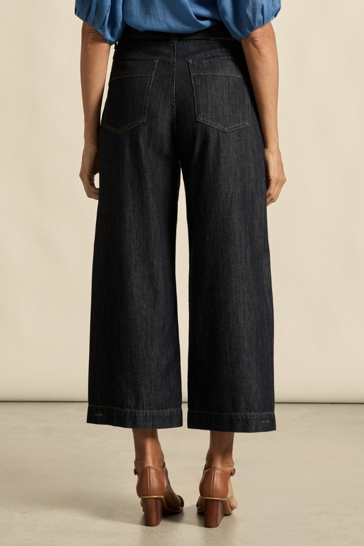 This back view of the Embark Jean in dark denim highlights the tailored fit, back pocket detailing, and high-rise design, available at Ivy Vibe.
