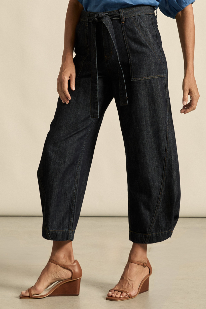 This side view of the Embark Jean in dark denim showcases its flattering fit, clean lines, and classic silhouette, available at Ivy Vibe.
