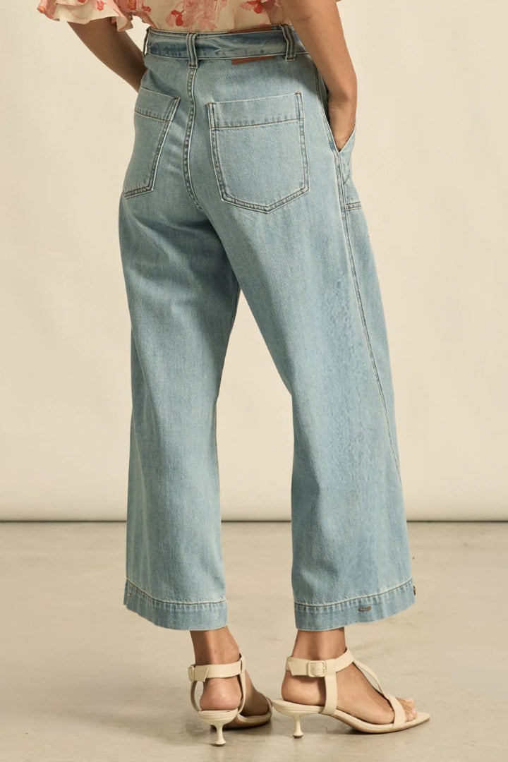 Light blue jeans worn by a person on a neutral background