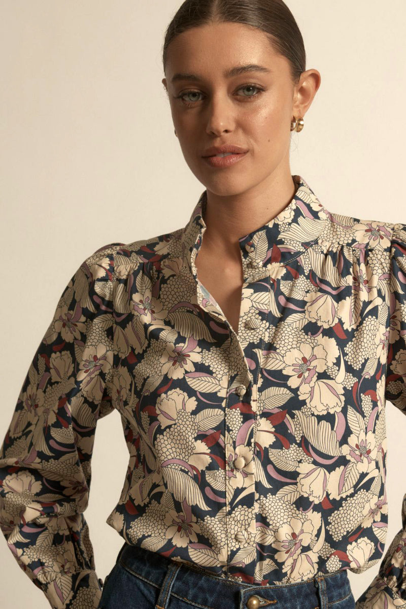 Woman wearing a long sleeve berry garden in beige background.