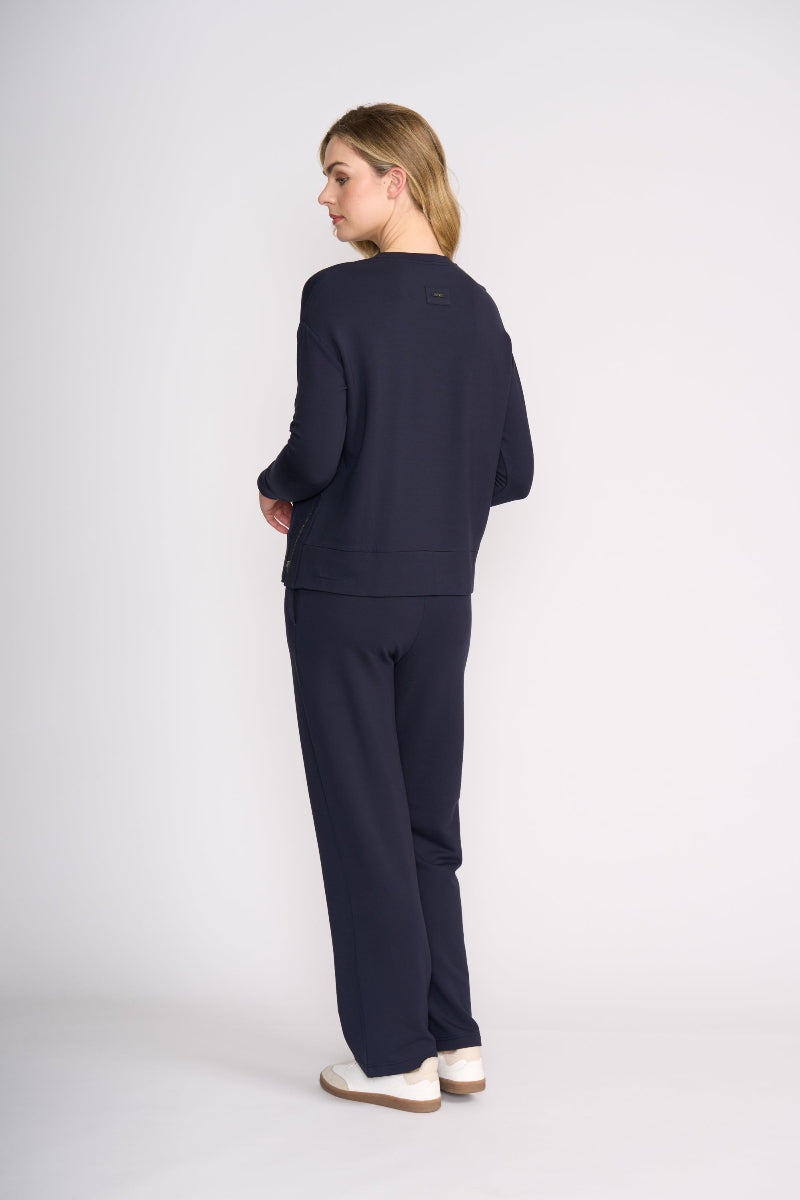 Woman wearing a navy outfit on a white background