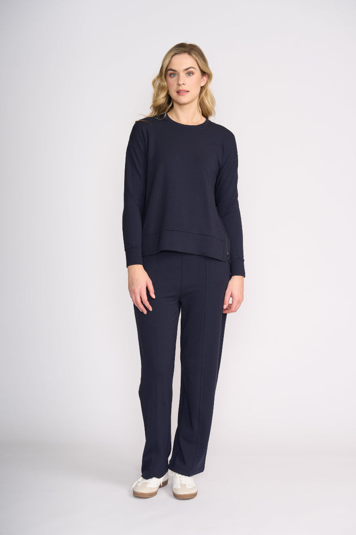 Woman wearing a navy blue outfit on a white background