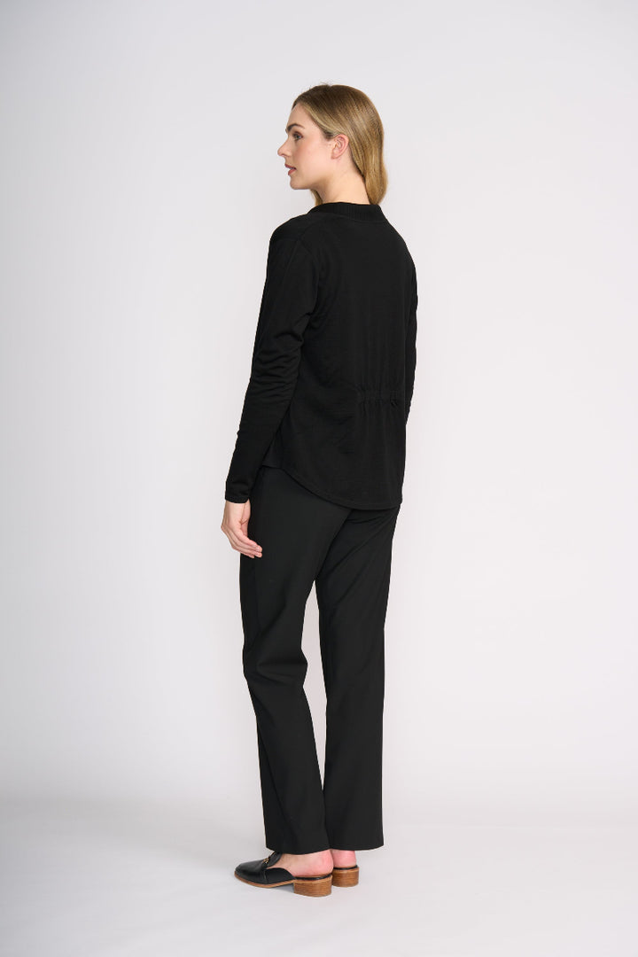 Woman wearing a black outfit on a white background