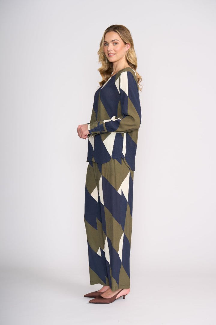 Woman wearing a patterned outfit on a white background