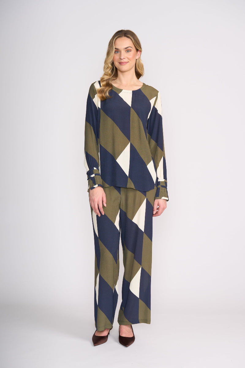 Woman wearing a patterned outfit on a white background