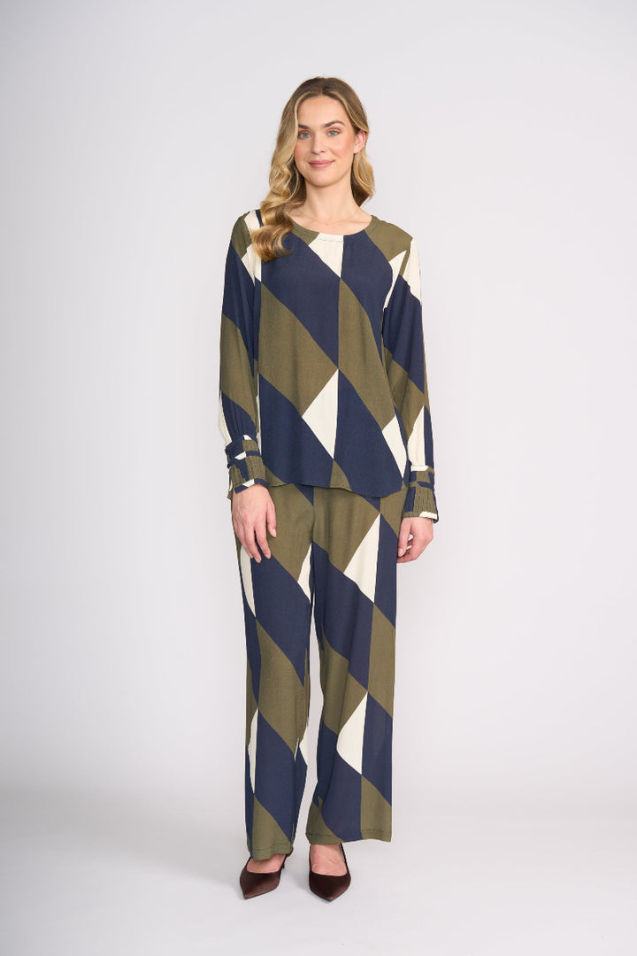 Woman wearing a patterned outfit on a white background