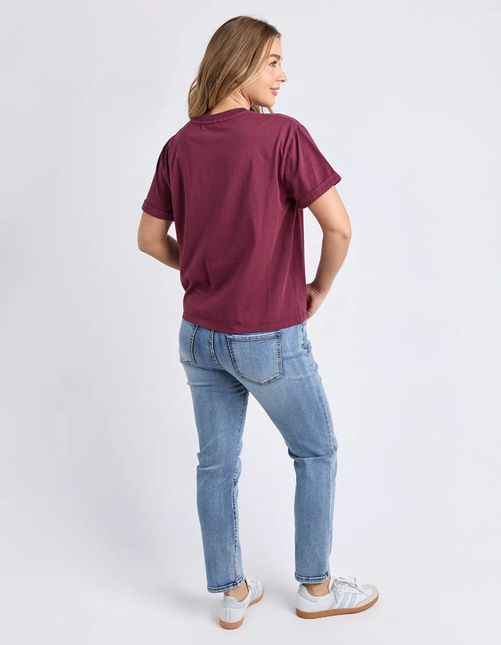 Wearing an oversized wine Tee short sleeves with Foxwood print with light blue skinny jeans.