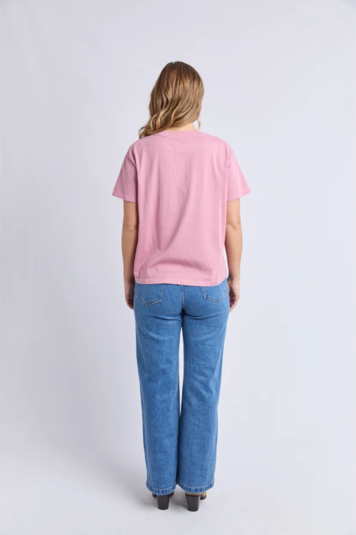 Person wearing a pink polo shirt and blue jeans on a white background