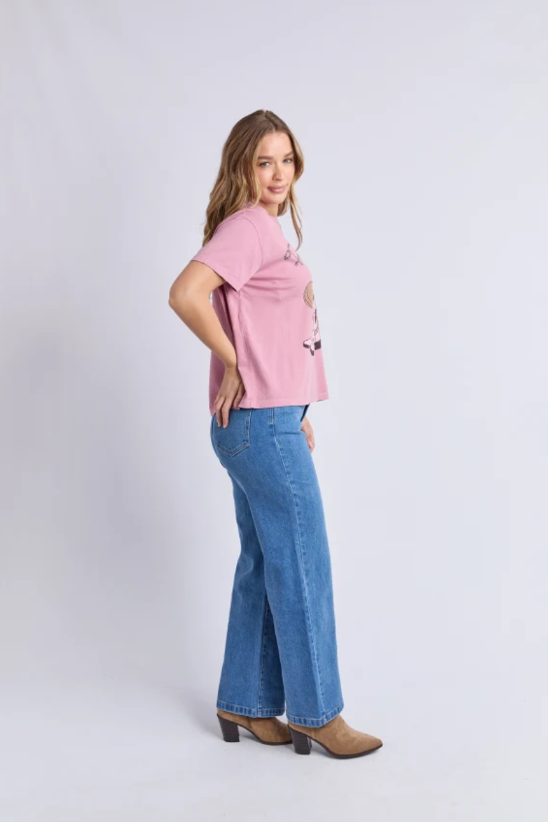 Woman wearing a pink top and blue jeans on a white background