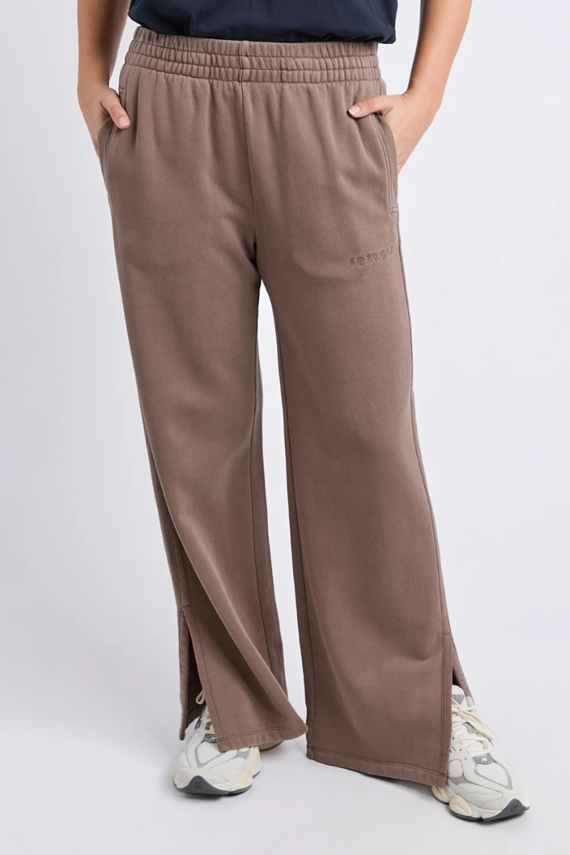 Brown wide-leg pants worn by a person on a white background