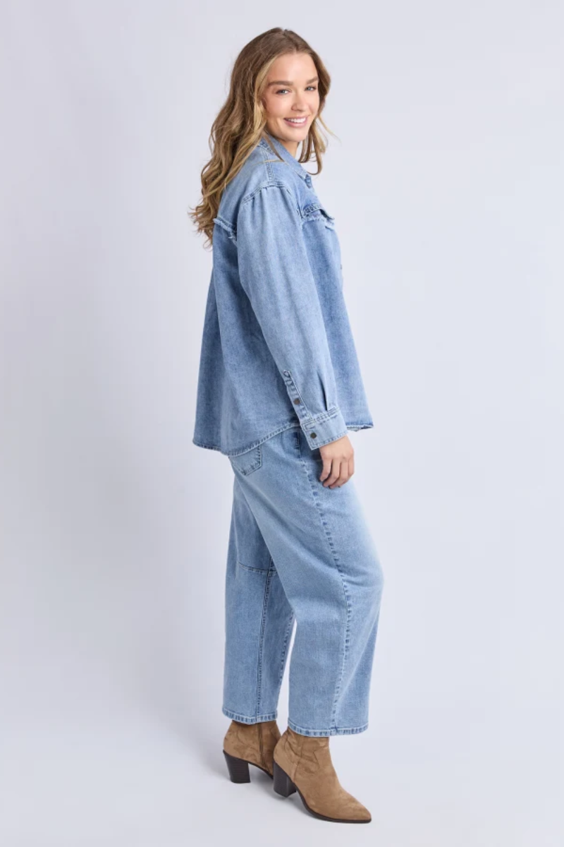 Woman wearing a denim outfit on a white background