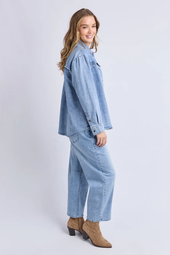 Woman wearing a denim outfit on a white background