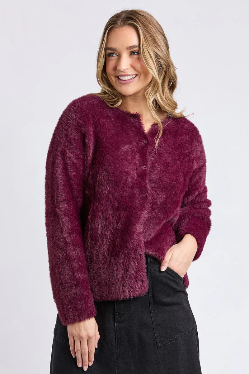 Woman wearing a burgundy fuzzy sweater against a white background