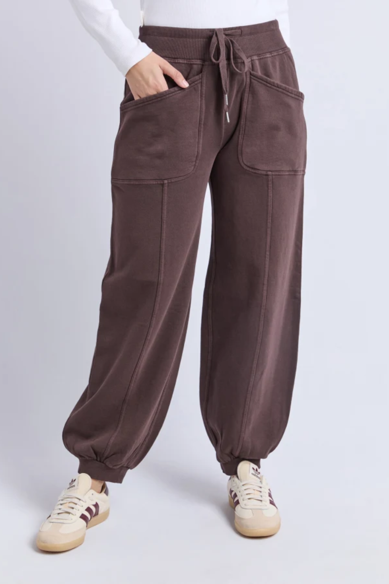 Brown pants worn by a person on a white background