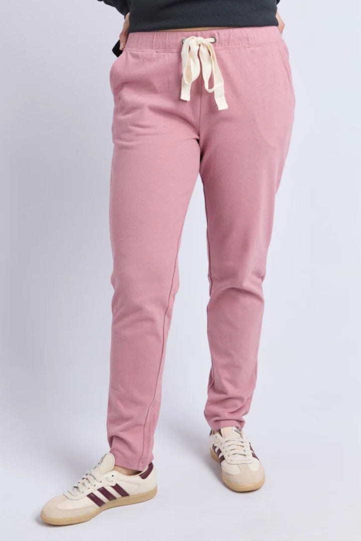 Pink sweatpants with a drawstring on a light gray background