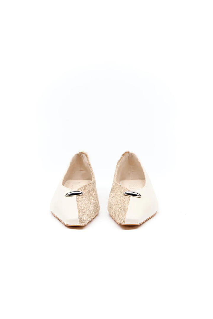 Pair of gold glittery flats on a white background
