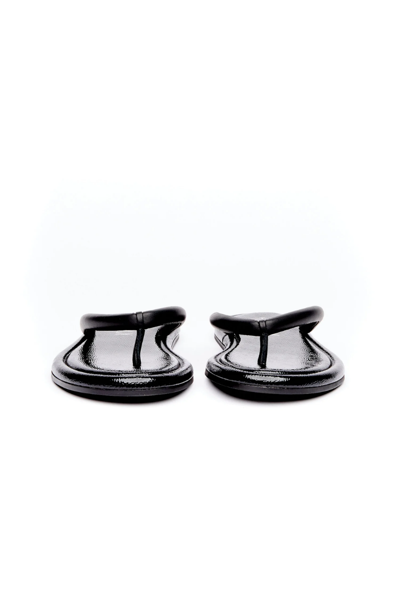 A pair of glossy black patent leather thong sandals shown from the back on a seamless white background.