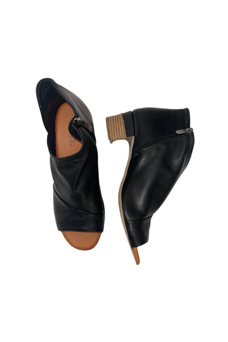 Black leather shoes with brown soles on a white background