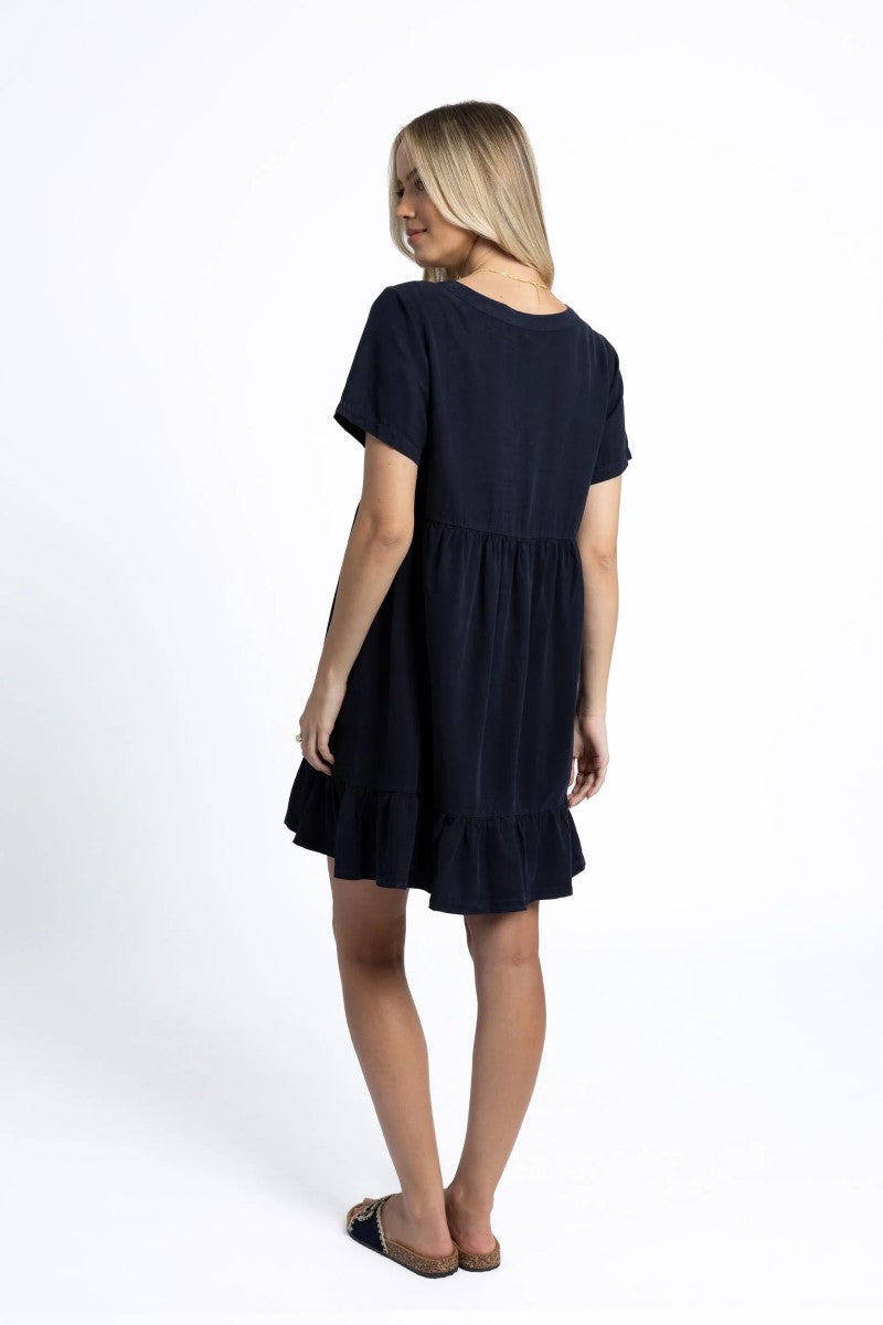 Woman wearing a navy blue dress on a white background