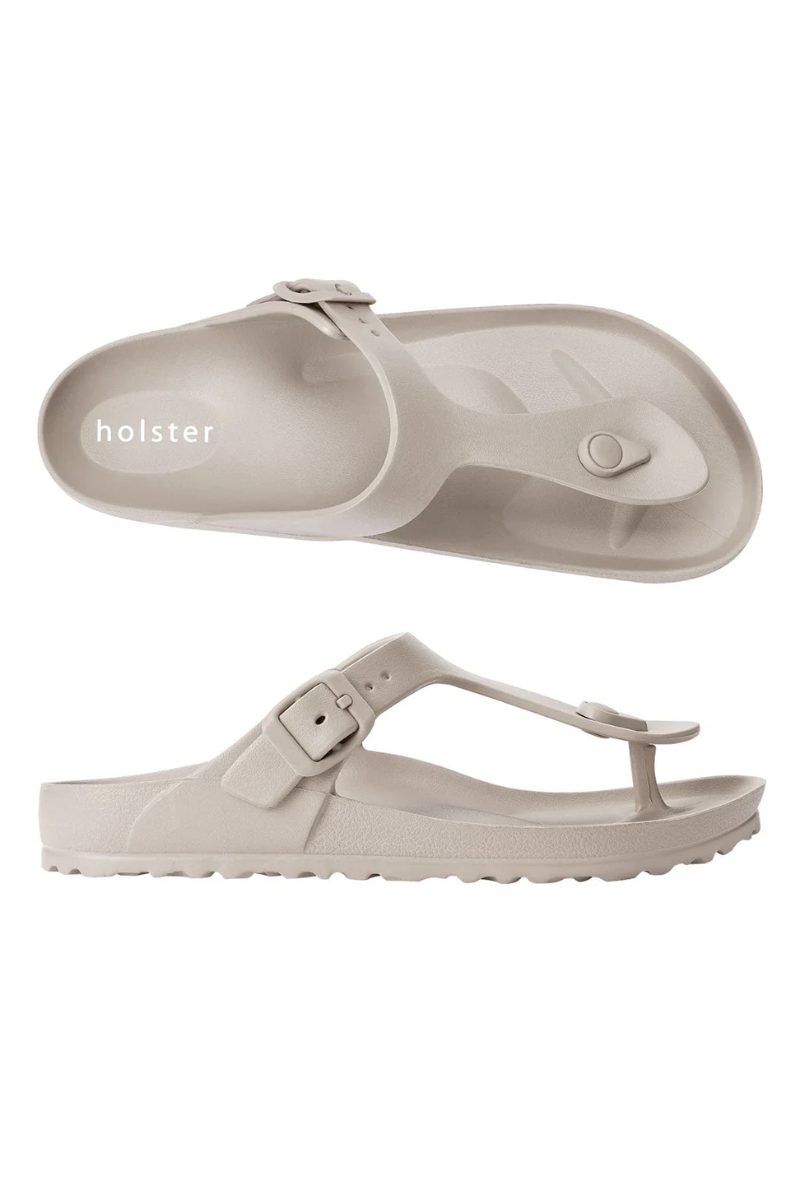 Beige sandals with 'holster' branding on a white background