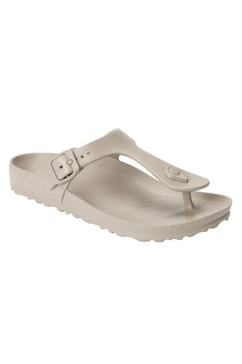 Beige sandal with a buckle on a white background