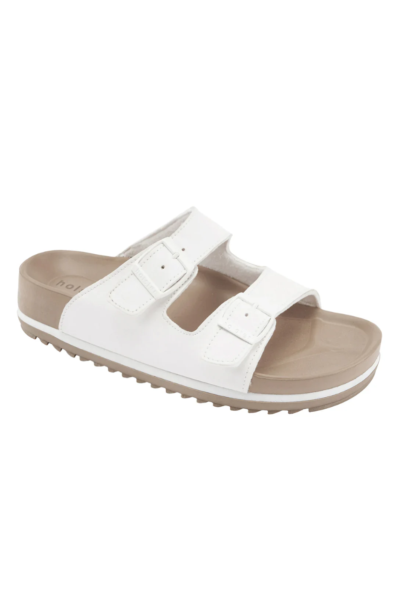 White sandal with brown sole on a white background