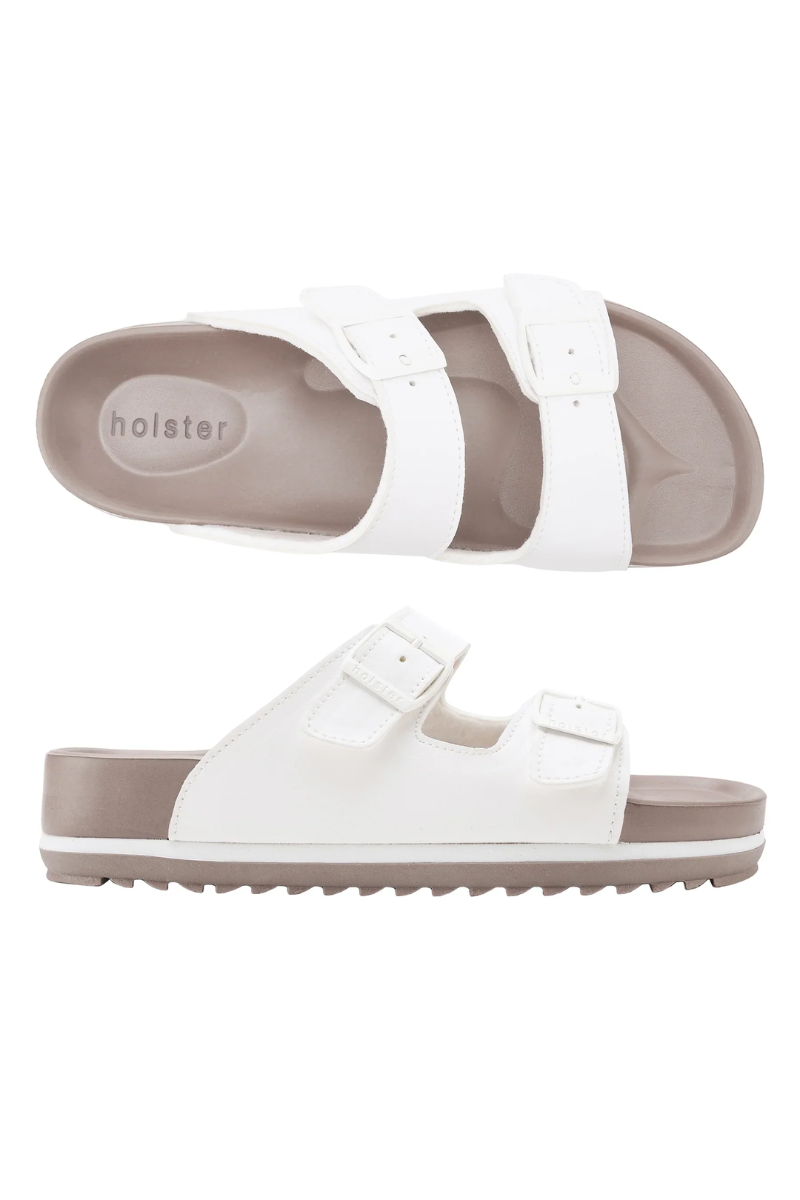 White sandals with brown soles on a white background