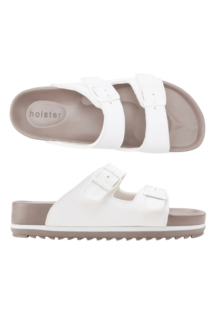 White sandals with brown soles on a white background