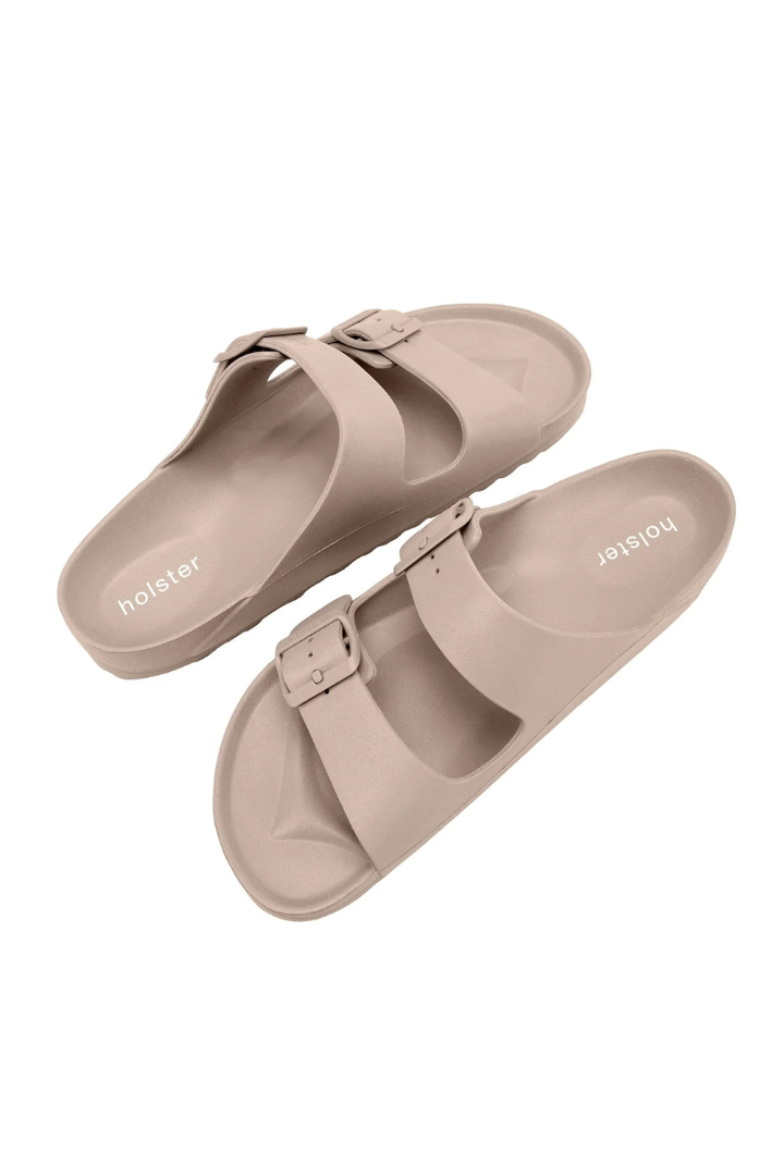 Pair of beige sandals on a white background