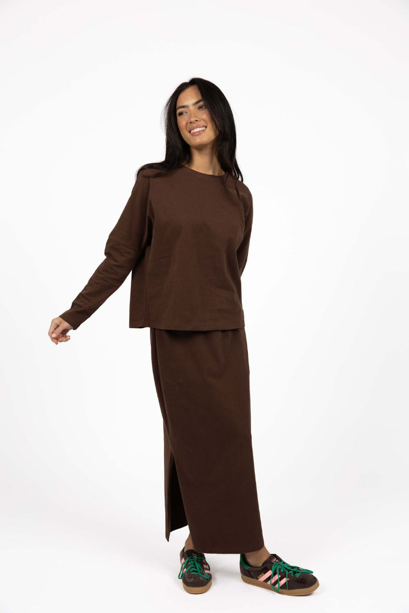 Woman wearing a brown outfit on a white background
