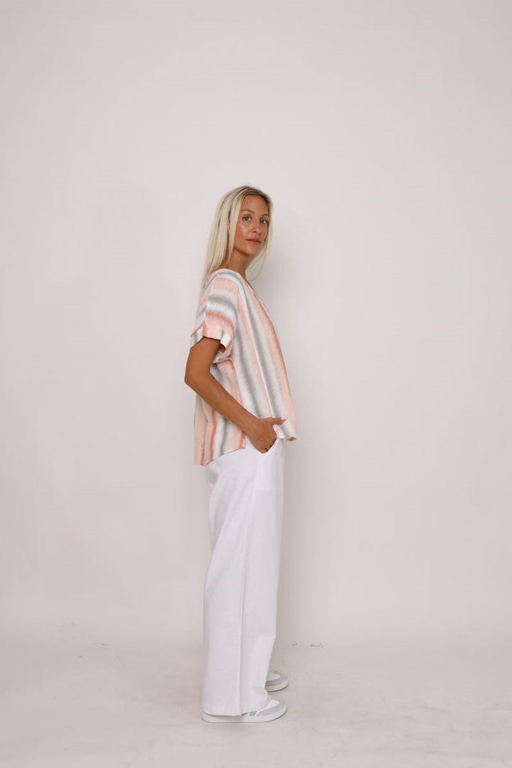 Side view of the Indrah Top in a striped design from Ivy Vibe, highlighting the relaxed fit, short sleeves, and soft, flowy silhouette.