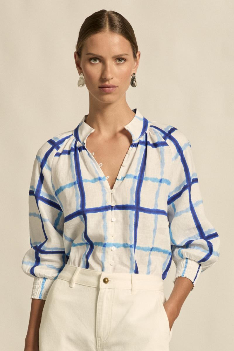 This front close-up image of the Inspire Top in Azure Check highlights the high stand collar, soft rounded neckline, and detailed elasticated rouleau loops on breathable linen fabric.
